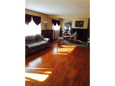 Huge living room with fireplace and wood floors