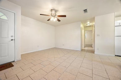Spare room with baseboards, ceiling fan, visible 