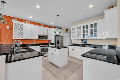 Kitchen featuring pendant lighting, sink, white ca
