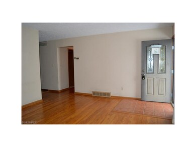 View of living room leading to dining room and hal