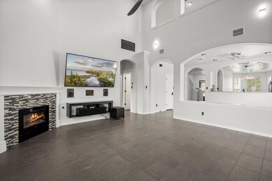 Unfurnished living room with ceiling fan, a firep