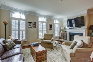 Living Room with triple crown molding, gas firepla