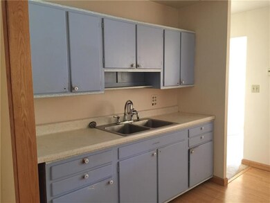 The kitchen is centrally located between the livin