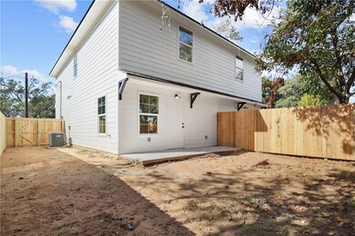Back of house featuring a fenced backyard, a patio