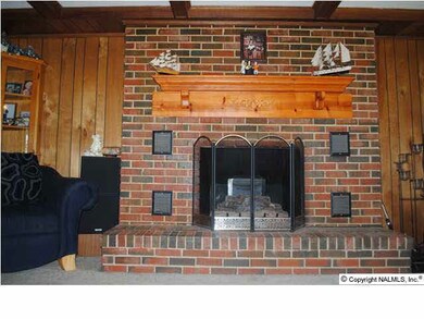The large brick fireplace has natural gas logs.
