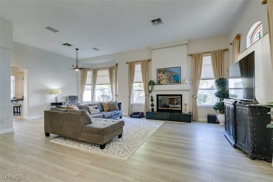 Living room with arched walkways, visible vents, a