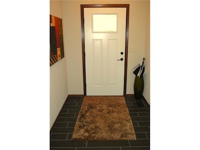 Front door entry with tiled flooring.