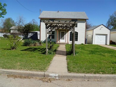 View of front facade with a pergola, a front lawn,