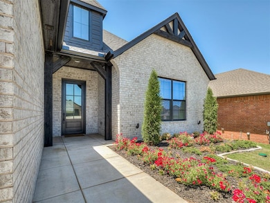 Entrance to property featuring brick siding and a shingled roof