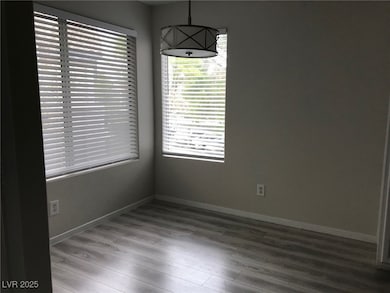 Unfurnished dining area with baseboards and light wood-type flooring