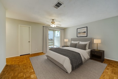 Virtually staged Primary Bedroom with balcony annd large walk-in closet.