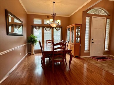 Dining area with ornamental molding, hardwood / wo
