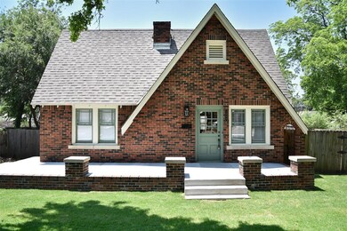 Tudor-style house with a front yard