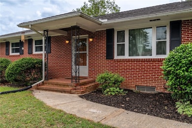 Property entrance featuring brick siding