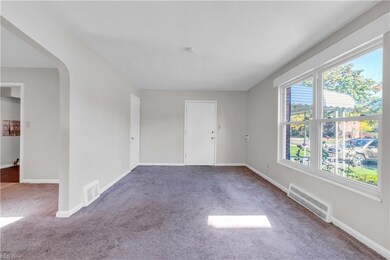 Empty room with light colored carpet