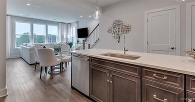 Kitchen featuring dishwasher, a sink, dark brown c