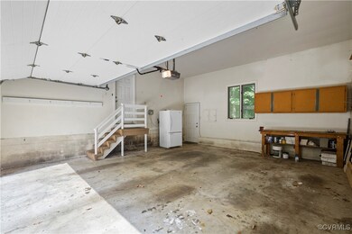 Garage with a garage door opener and white fridge