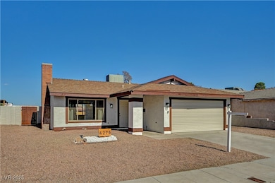 Ranch-style home with stucco siding, driveway, a garage, and a chimney