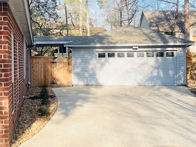 2 Arched gates at garage & roses in rock at drivew
