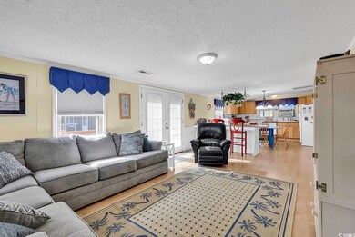 Living room with crown molding, a textured ceiling