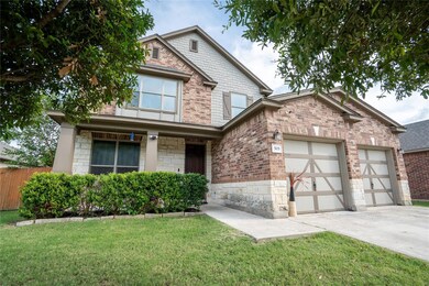 Traditional-style home featuring a garage, concre