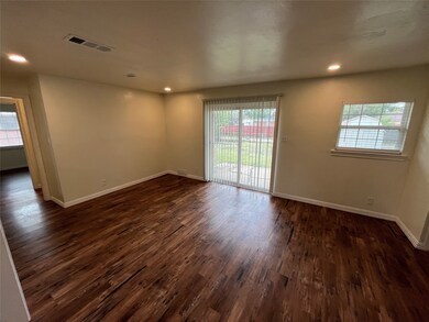 Unfurnished room with healthy amount of natural light, dark wood-style floors, and recessed lighting