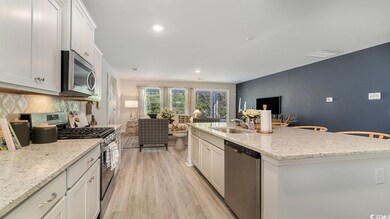 Kitchen featuring white cabinetry, stainless steel