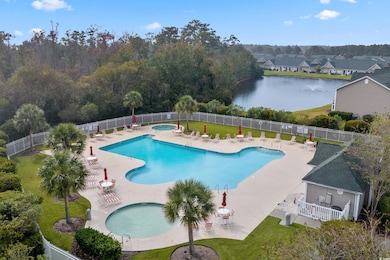 Community pool with a hot tub, a patio area, and a