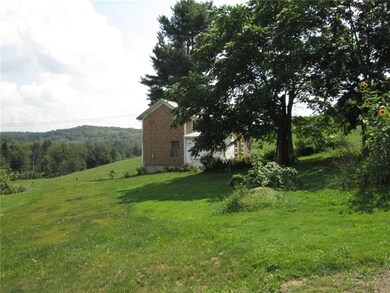 A distant view of the home and surrounding rolling