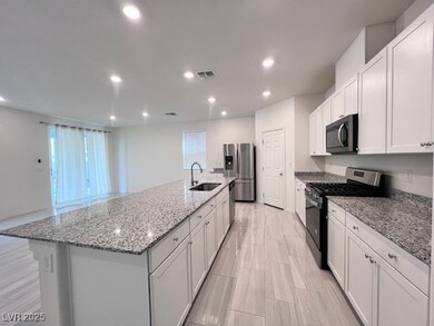 Kitchen with sink, stone countertops, a large isla