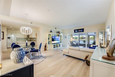 Living room featuring a chandelier, baseboards, vi