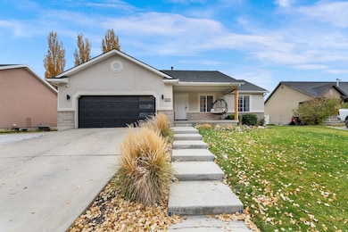 Ranch-style home with stucco siding, a porch, driveway, and a garage