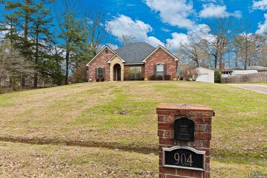 View of front facade with brick siding, a shingled