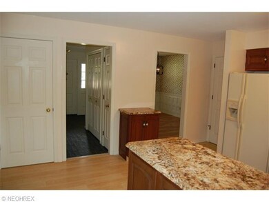 From left to right: door to basement, slate floor access to foyer, dining room access.