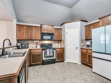 Spacious kitchen with tile flooring.