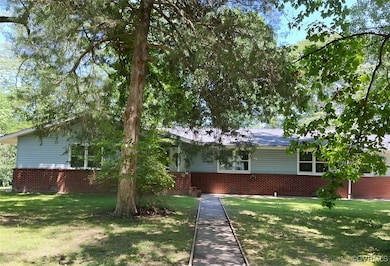 Ranch-style house featuring brick siding and a fro