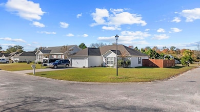 View of front of home featuring concrete driveway and a garage