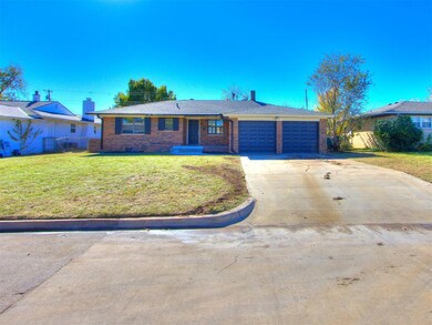 Ranch-style home featuring a front lawn and a gara