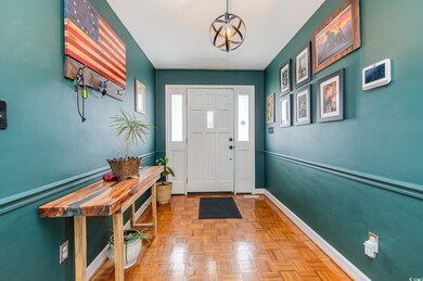 Entrance foyer with light parquet flooring