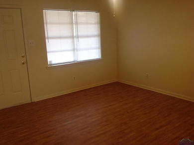 Spare room with dark hardwood / wood-style floors