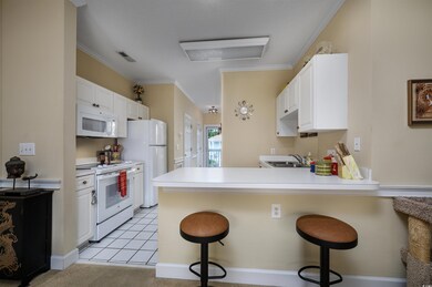 Kitchen featuring light tile patterned floors, whi