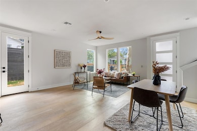 Dining space with healthy amount of natural light, light wood-type flooring, and a ceiling fan