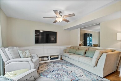 Picture frame moulding in the family room adds a touch of elegance and the cutout to living room enhances the open floor plan.