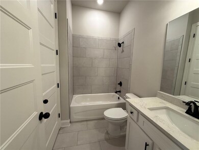 Full bath with vanity, shower / bathtub combination, and light tile patterned floors