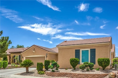 View of front facade with an attached garage, stuc