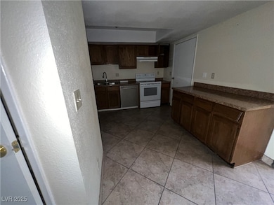 Kitchen with white electric range, stainless steel