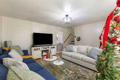 Living room with wood finished floors and stairway