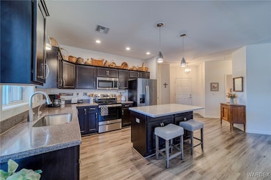 Kitchen with a center island, pendant lighting, vi