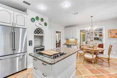 Chef's Kitchen with Stainless Appliances and Wine 