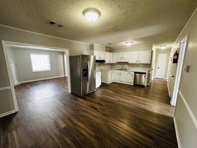 Kitchen with visible vents, a sink, stainless stee